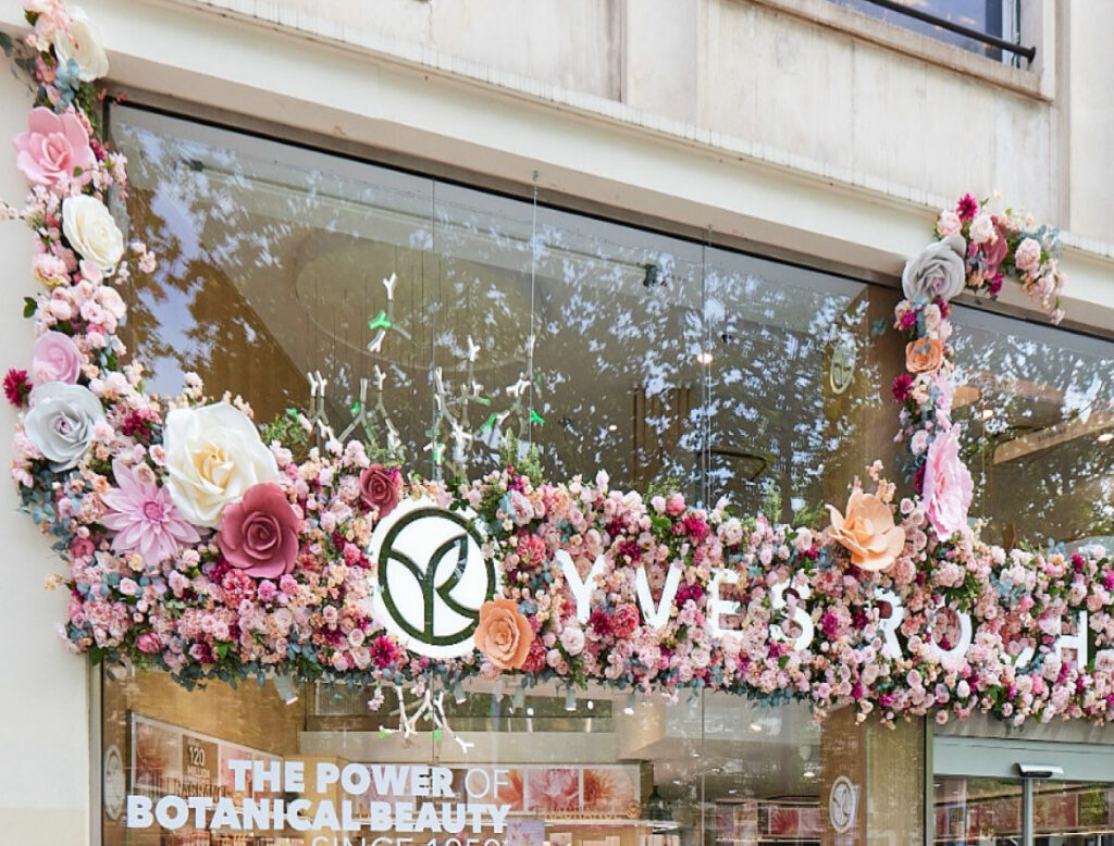 Décor floral extérieur Yves Rocher avec fleurs monumentales réalisées par Atelier Pirina